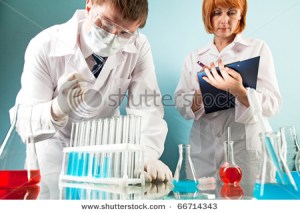 stock-photo-masked-clinician-working-with-flasks-in-laboratory-with-nurse-making-notes-near-by-66714343