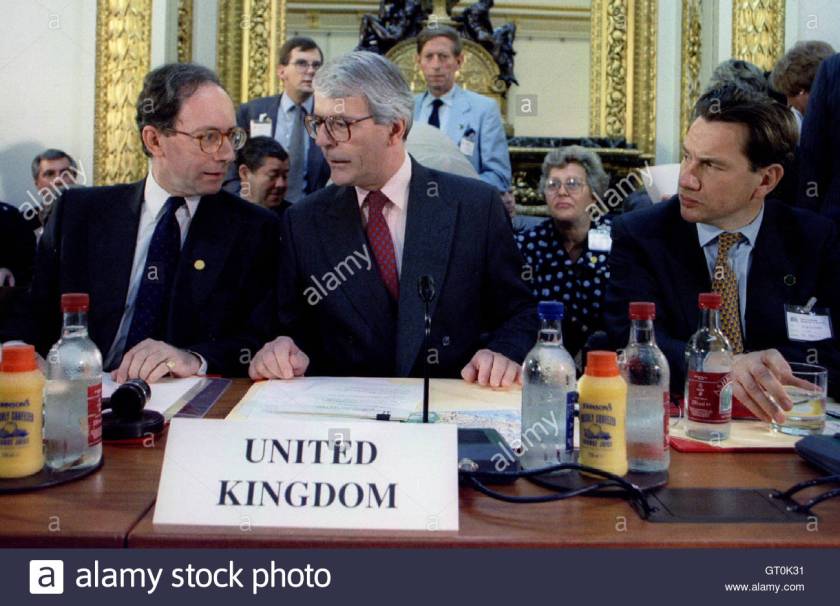 Prime Minister John Major (C) and Foreign Secretary Malcolm Rifkind (L) talk, watched by Defence Sec..